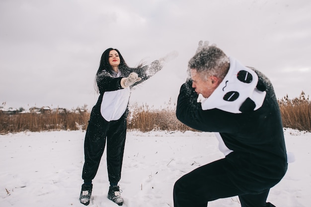 Winter love story, a beautiful young couple in panda suits