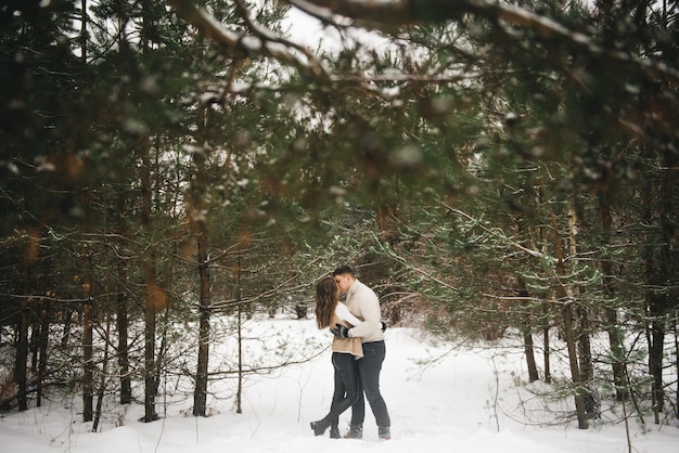 Winter love story on ice. Stylish lovers boy and girl on a snowy scene . Romance