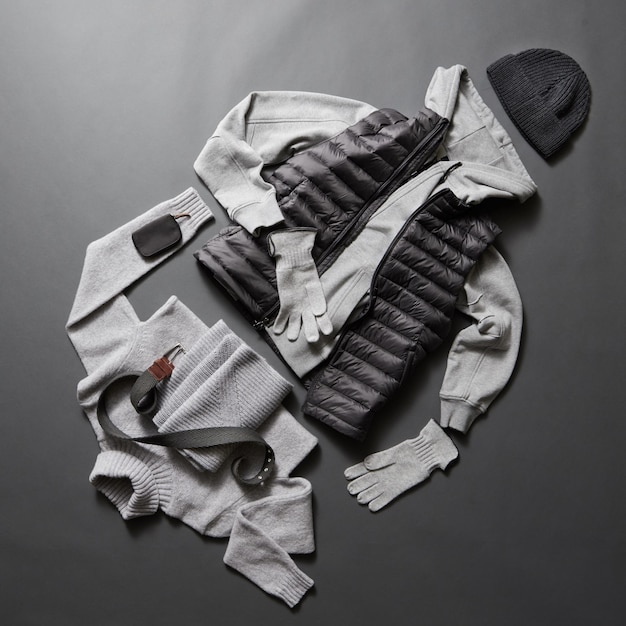 Winter men's clothes and accessories on a black surface