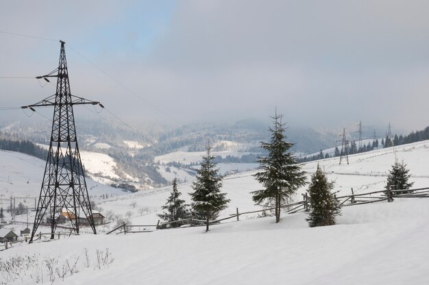 Winter mountain landscape with high-voltage current line