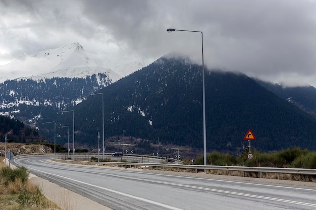 Winter in the mountains Epirus region Greece and country road on a winter day