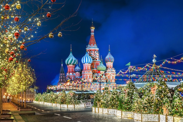 Winter night on the Red Square in Moscow and St. Basil's Cathedral and Christmas decorations on fir trees and trees