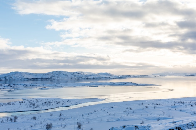 Winter panorama with snow and ice on lake Thingvellir Iceland view from parking