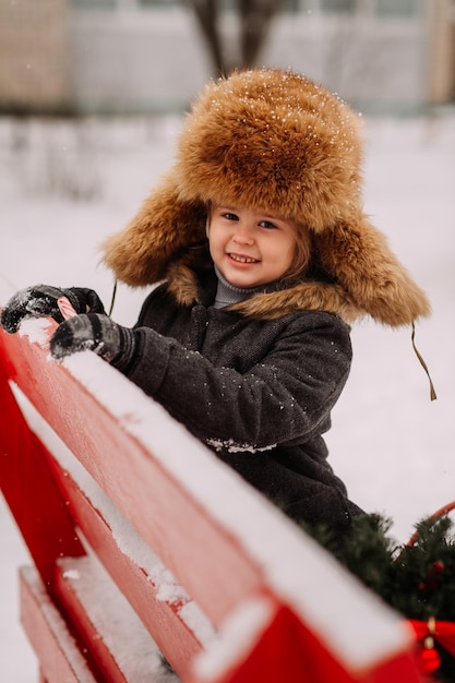 Winter portrait of a child on a bench 3129