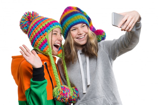 Winter portrait of two happy beautiful teenage girlfriends