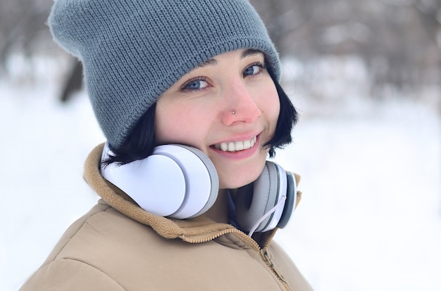 Winter portrait of young girl with headphones