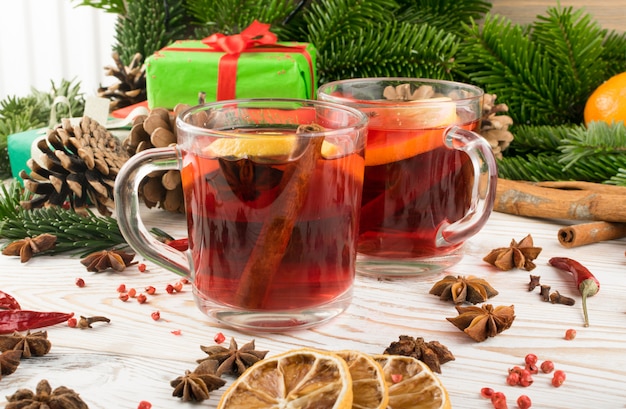 Winter red drink with spices on festive new year background