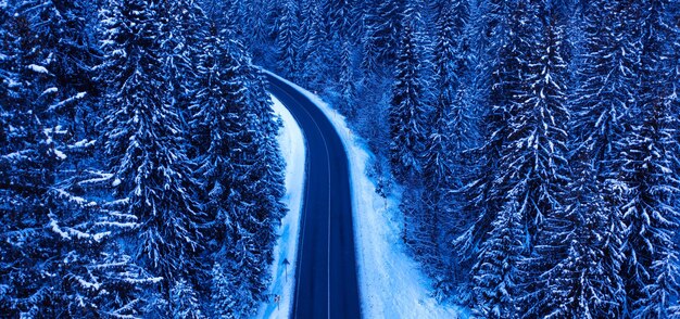 Winter road in the mountains drone view