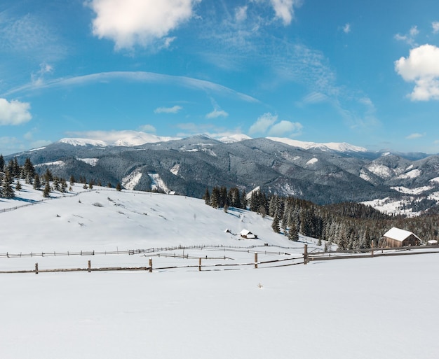 Winter snowy mountains and lone farmstead