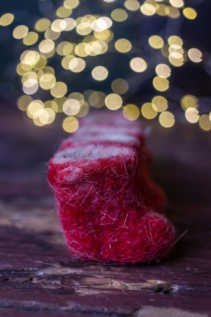 winter still life small red felt boots on a dark background