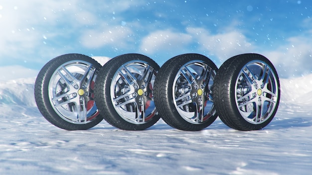 Winter tires on blue sky background, snowfall and slippery winter road. Winter concept road safety