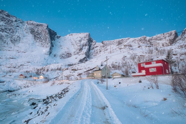 Winter wonderland of traditional fishing village and snow covered mountain on winter at Lofoten Islands