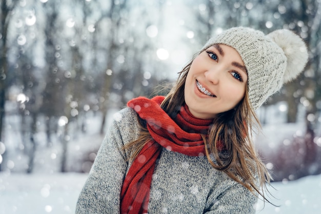 Winter young woman portrait beauty joyful girl laughing and having fun in winter park