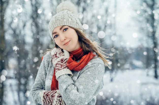 Winter young woman portrait. Beauty Joyful Model Girl laughing and having fun in winter park. Beautiful young female outdoors, Enjoying nature, wintertime