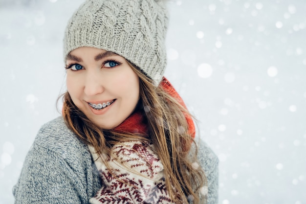 Winter young woman portrait. Beauty Joyful Model Girl laughing and having fun in winter park. Beautiful young female outdoors, Enjoying nature, wintertime