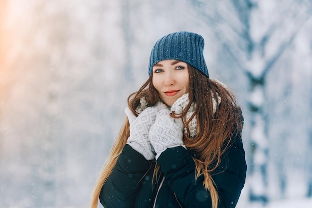 Winter young woman portrait Beauty Joyful Model Girl laughing and having fun in winter park Beautiful young woman outdoors Enjoying nature wintertime