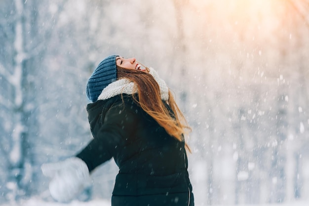 Winter young woman portrait Beauty Joyful Model Girl laughing and having fun in winter park Beautiful young woman outdoors Enjoying nature wintertime