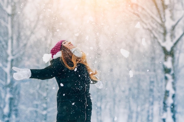 Winter young woman portrait Beauty Joyful Model Girl laughing and having fun in winter park Beautiful young woman outdoors Enjoying nature wintertime