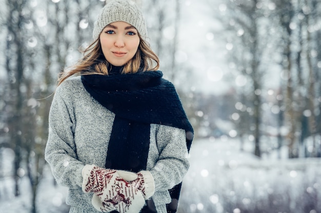 Winter young woman portrait beauty joyful model girl laughing and having fun in winter park