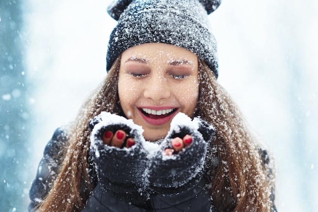 Winter young woman portrait. Beauty Joyful Model Girl laughing and having fun in winter park