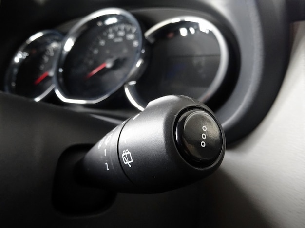 Wiper switch close up shot with soft focus on dashboard in car interior