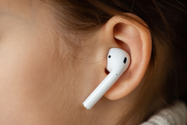 Wireless earphone in the girls ear