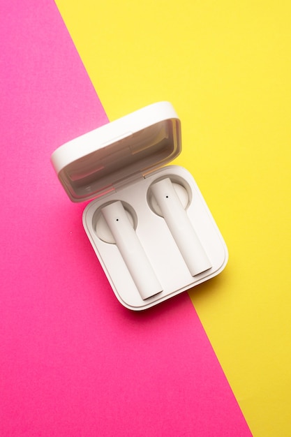 Wireless headphones on a pink background