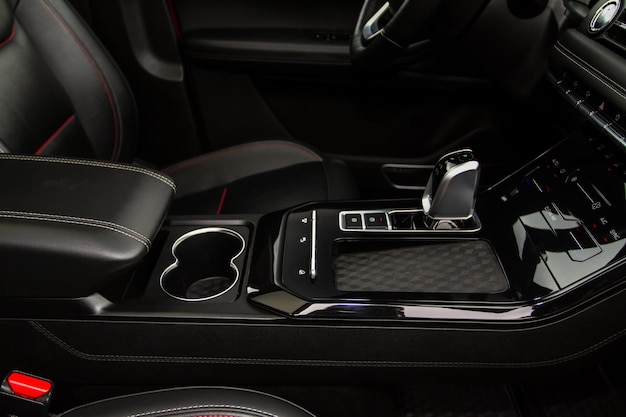 Wireless mobile charger in the modern car. Portable wireless car charger for smartphone.