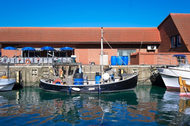 Wismar old warehouses of the Old Hansa Harbor Fishermen boats with reflection