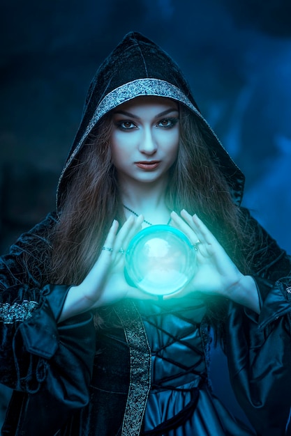 The witch with magic ball in her hands causes a spirits