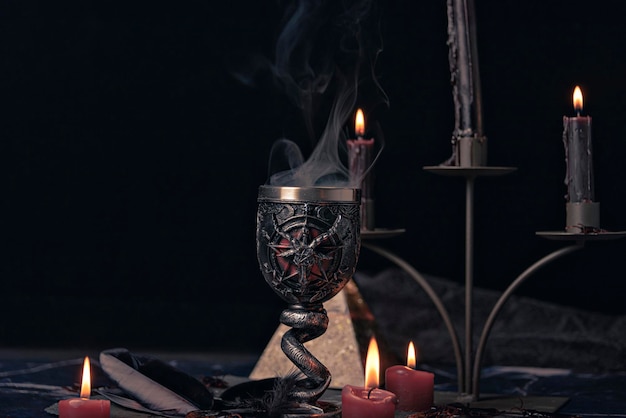 Witchcraft composition with burning candles jewelry and pentagram symbol Halloween