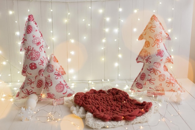 A with christmas decorations and a red and white pillow with a tree on it