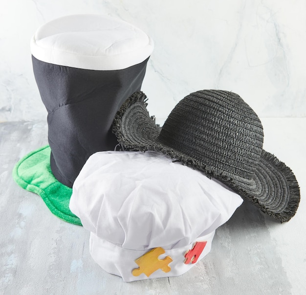 Wizard's hat chef's hat and sun hat on a wooden background