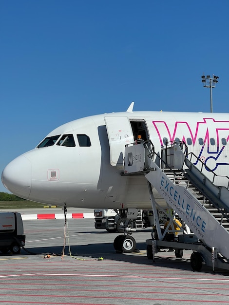 Wizz Air plane with a ladder at the airport Closeup