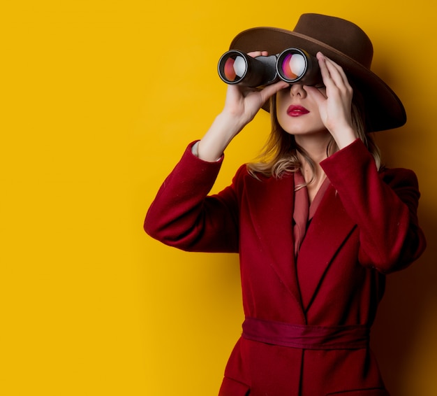 Woman in 1940s style clothes and binoculars 