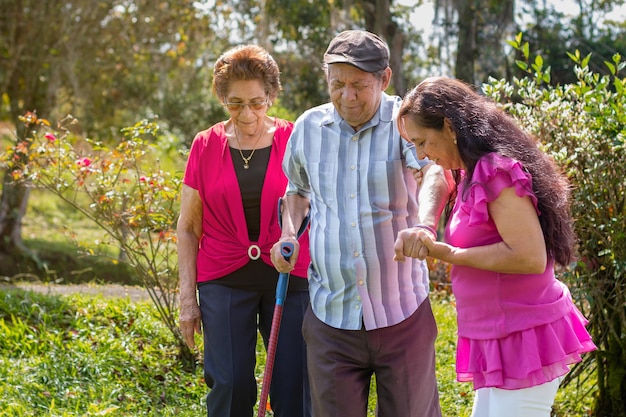 Woman accompanying her elderly parents on a walk in the countryside Active aging and family support