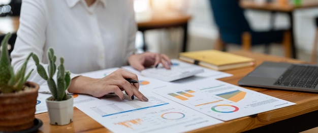 Woman accountant working with computer and calculator for business and financial expense