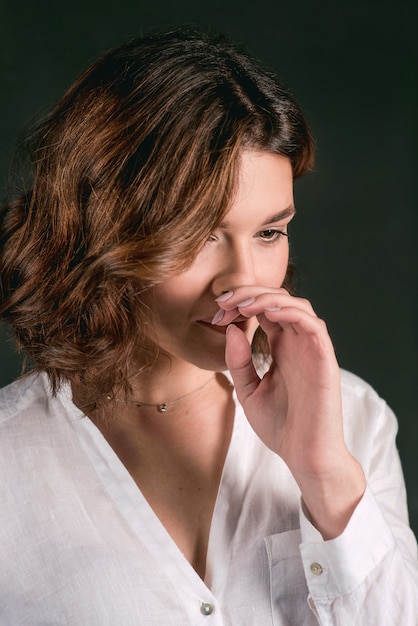 woman actress with short brown hair in white shirt and blue pants