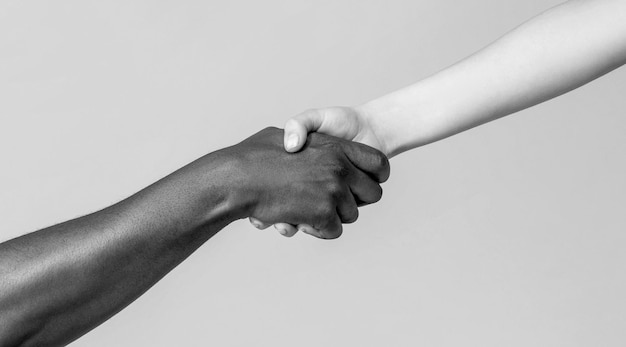 Woman and african woman hand Helping hand Rescue multiathnic people Helping hands Rescue gesture Black and white