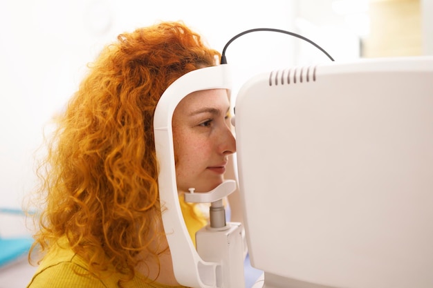 A woman during am eye pressure measurement at her eye clinic