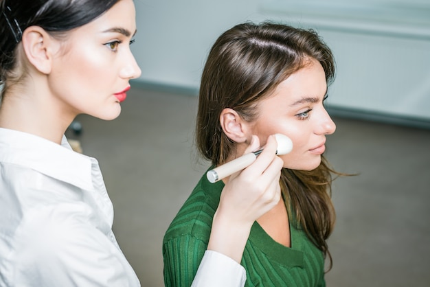 Woman applying cosmetic