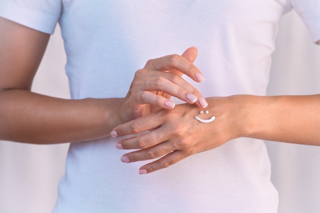 Woman applying hand cream or moisturizer Hand skin care