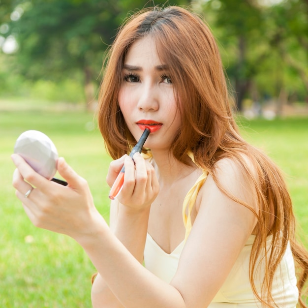 Woman applying lipstick