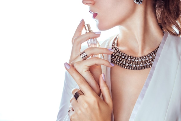 Woman applying perfume on her neck