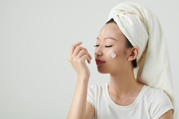 Woman Applying Renewing Lotion