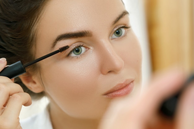 Woman applying tinted eyebrow gel