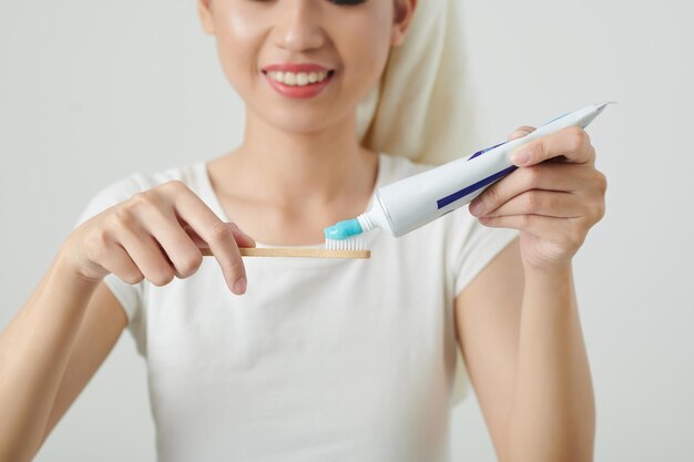 Woman Applying Toothpaste on Brush