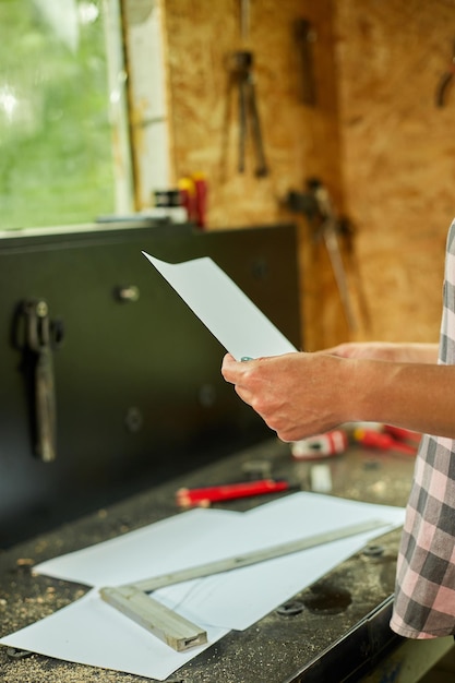 Woman architect check plan of new apartment design at workshop