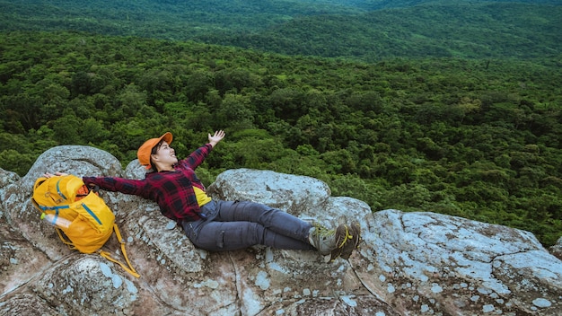 Woman asians travel relax in the holiday. View mountain nature on the cliffs.