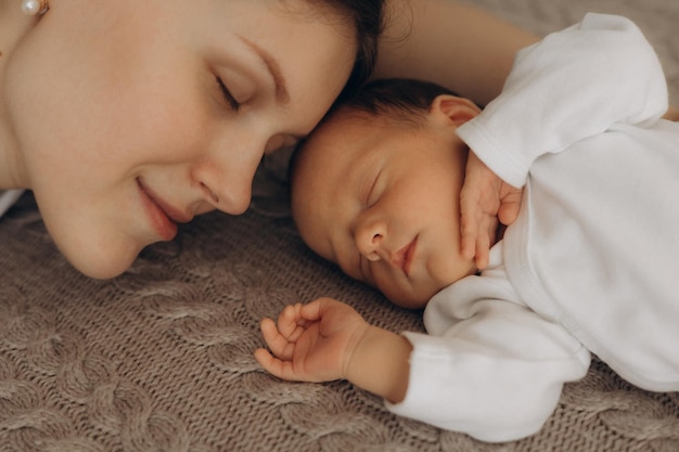 a woman and a baby are sleeping on a carpet